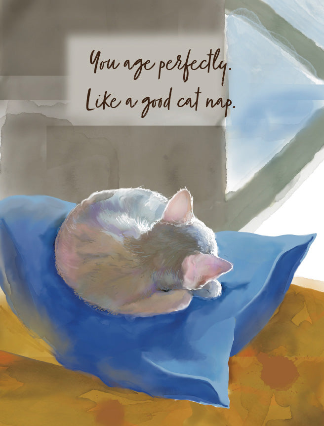 Watercolor-style illustration of a sleeping cat curled up on a blue pillow, with the text 'You age perfectly. Like a good cat nap.' Original artwork by Susan J. York.