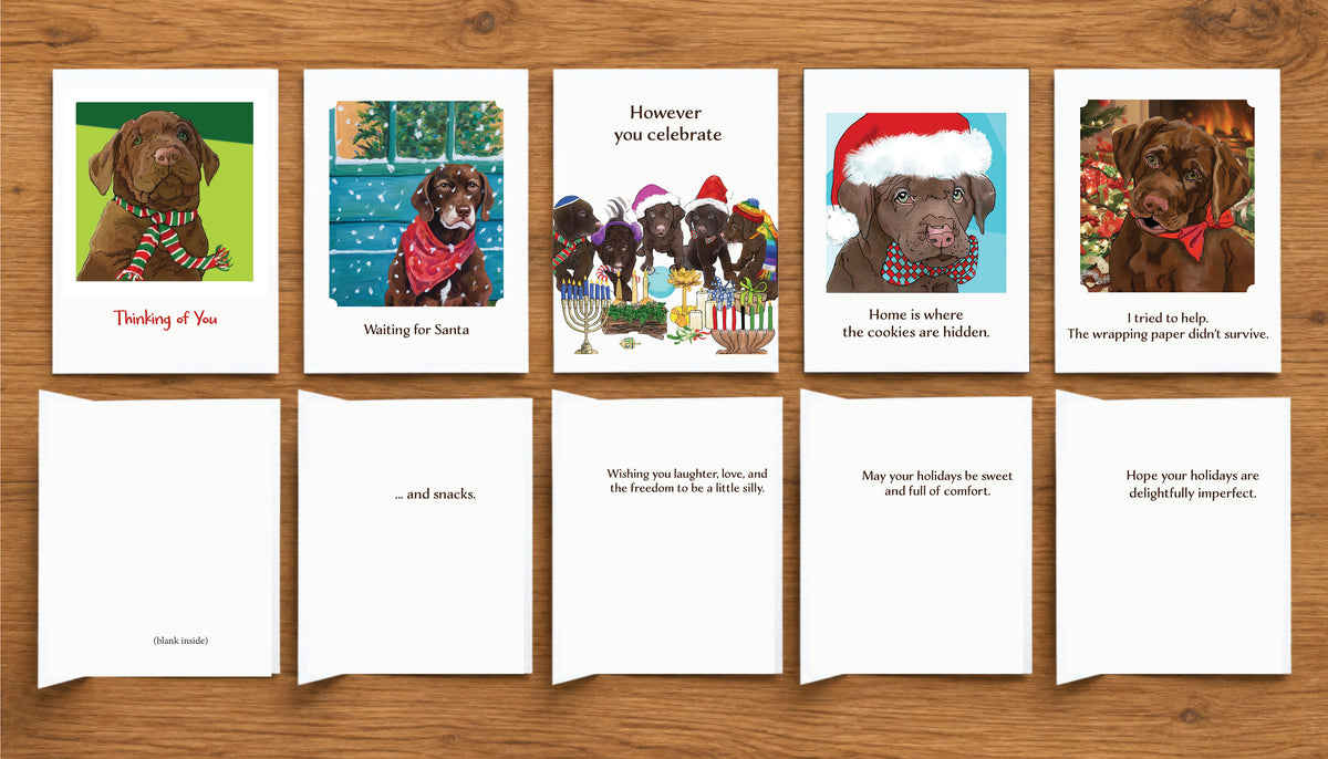 Five Christmas and holiday greeting cards featuring original dog artwork by Susan J. York, shown with their inside messages. The collection includes playful winter and Christmas designs with Brown Dog Ink humor and warmth.