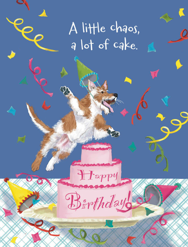 A square greeting card illustration featuring a brown and white dog wearing a party hat jumping onto a pink tiered birthday cake. The card has a blue background with scattered confetti, streamers, and the text 'A little chaos, a lot of cake. Original artwork by Susan J. York.