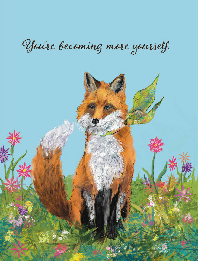 A square greeting card or art print featuring an illustrated red fox sitting in a flower field with the text 'You're becoming more yourself.' at the top against a light blue background.Original artwork by Susan J. York.
