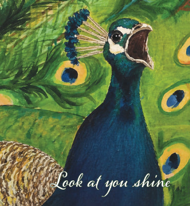 A colorful painting of a peacock with its beak open, set against a green background with peacock feather eye spots. The text 'Look at you shine' is written across the bottom. Original artwork by Susan J. York.