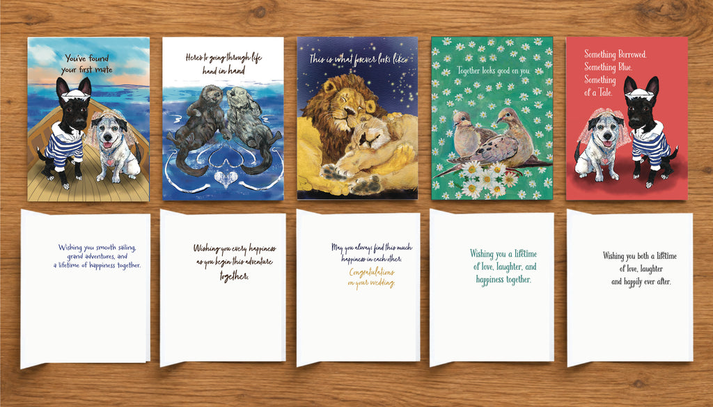 Five illustrated Wedding Celebration cards by Susan J. York shown with their exterior artwork and interior messages on a wood tabletop for Brown Dog Ink.