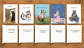 Five illustrated animal birthday cards by Susan J. York arranged on a wooden surface, showing colorful front artwork and coordinating inside birthday messages.